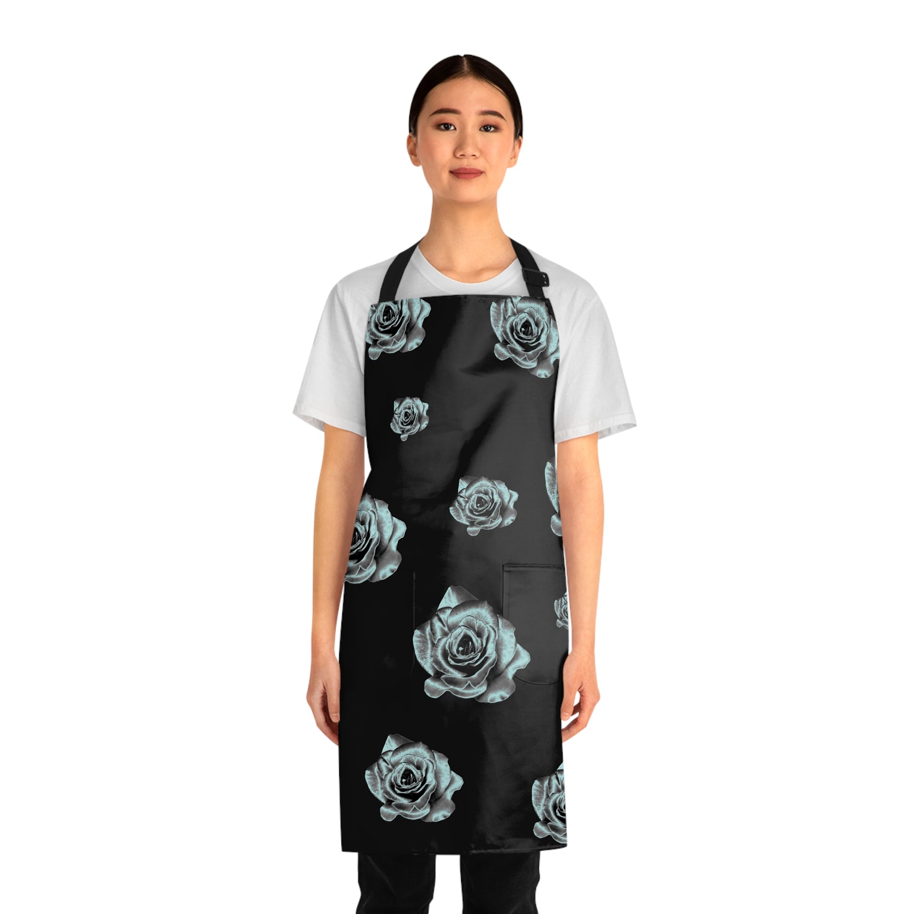 front view of girl wearing a grilling apron with a black and silver rose pattern on it and black straps