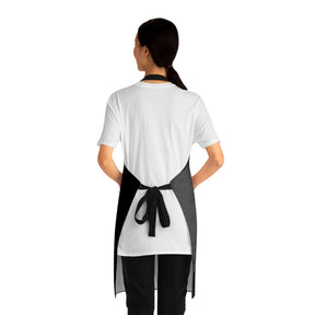 back view of a woman wearing a black grilling apron with black straps