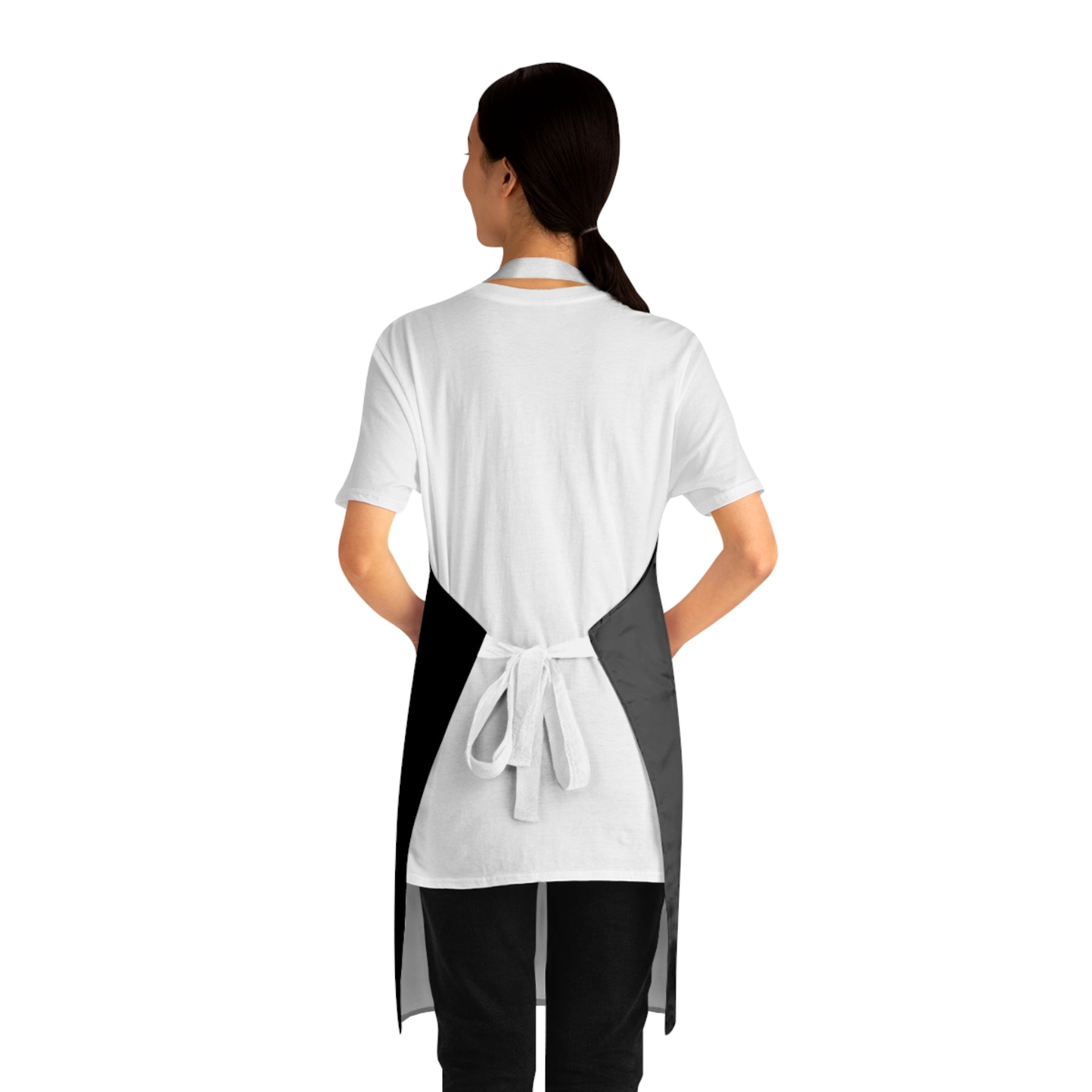 back view of a woman wearing a black apron with white straps