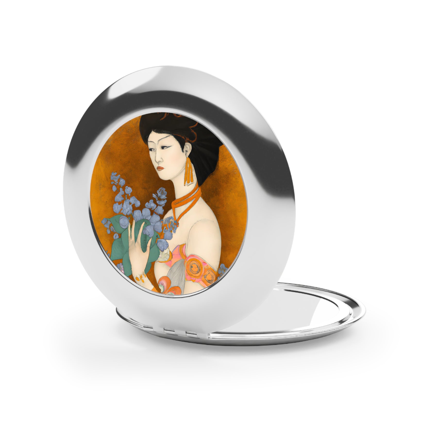 front view of an open compact mirror with a painted image of a Geisha holding some violets