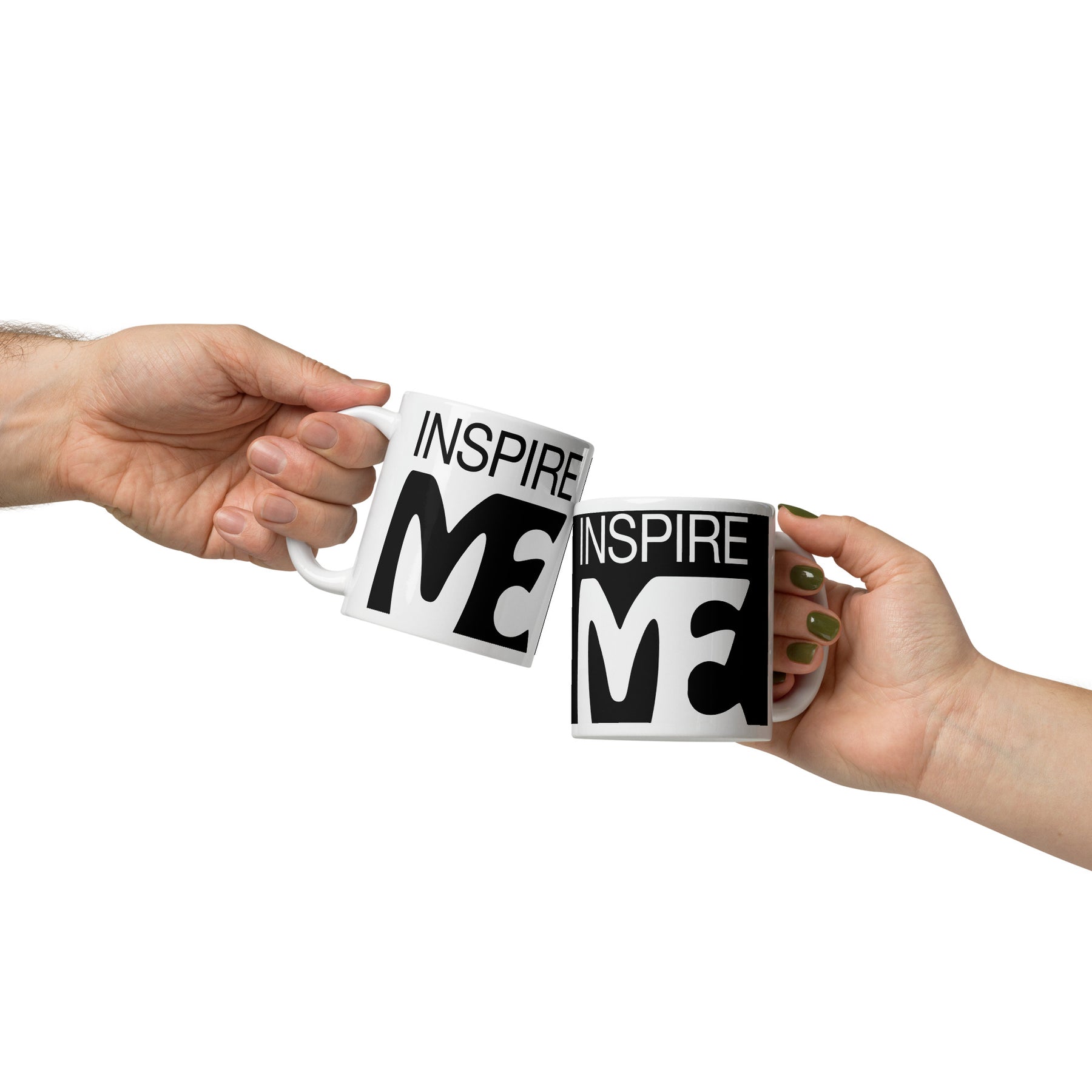 view of two hands each with a black and white mug that says "inspire me"