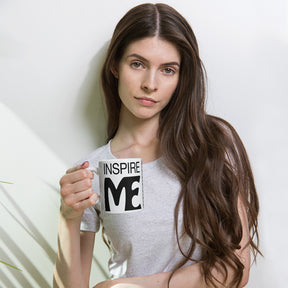 view of a woman holding a black and white mug that says "inspire me"