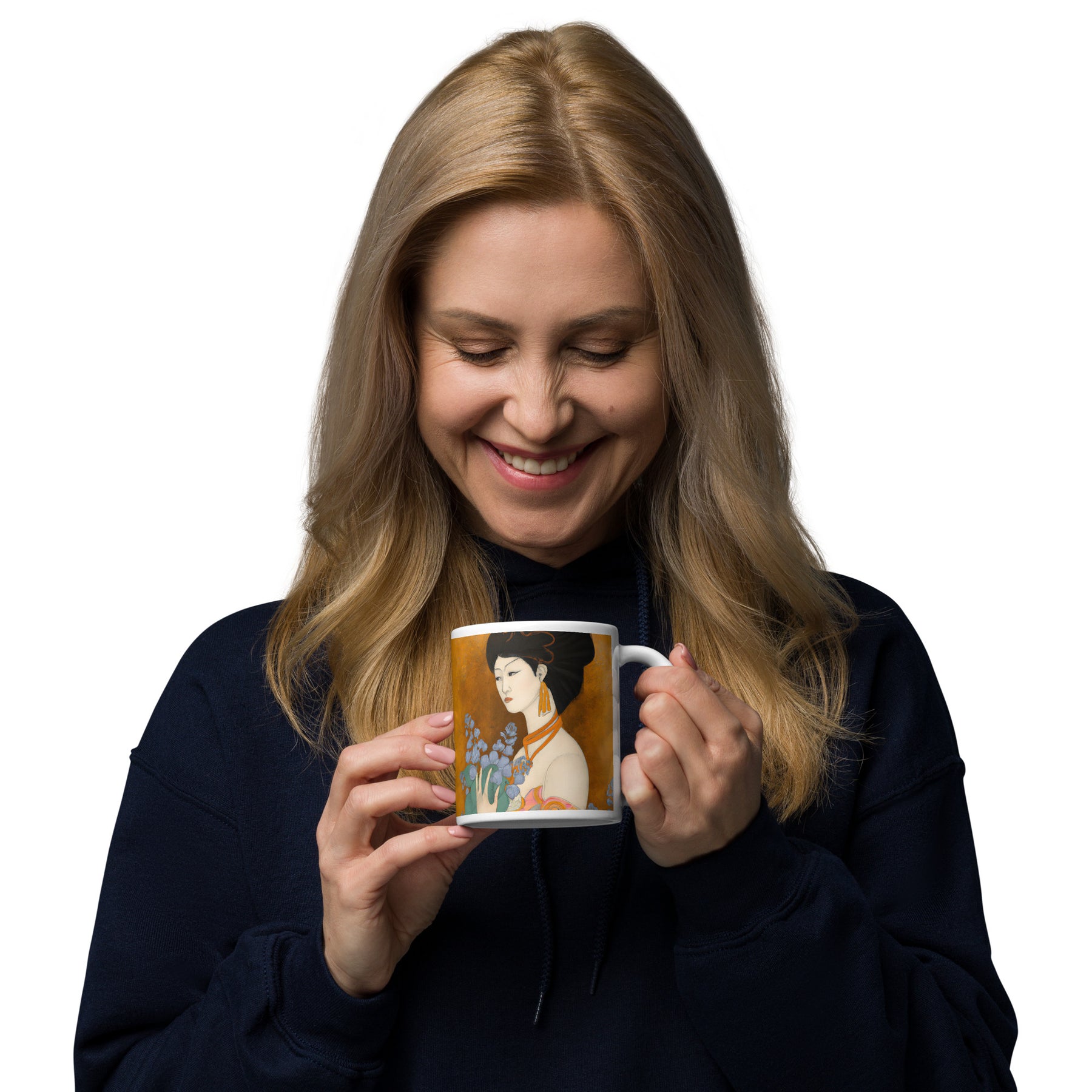 smiling woman looking onto a Coffee Mug with a painted image of a Geisha holding some violets 