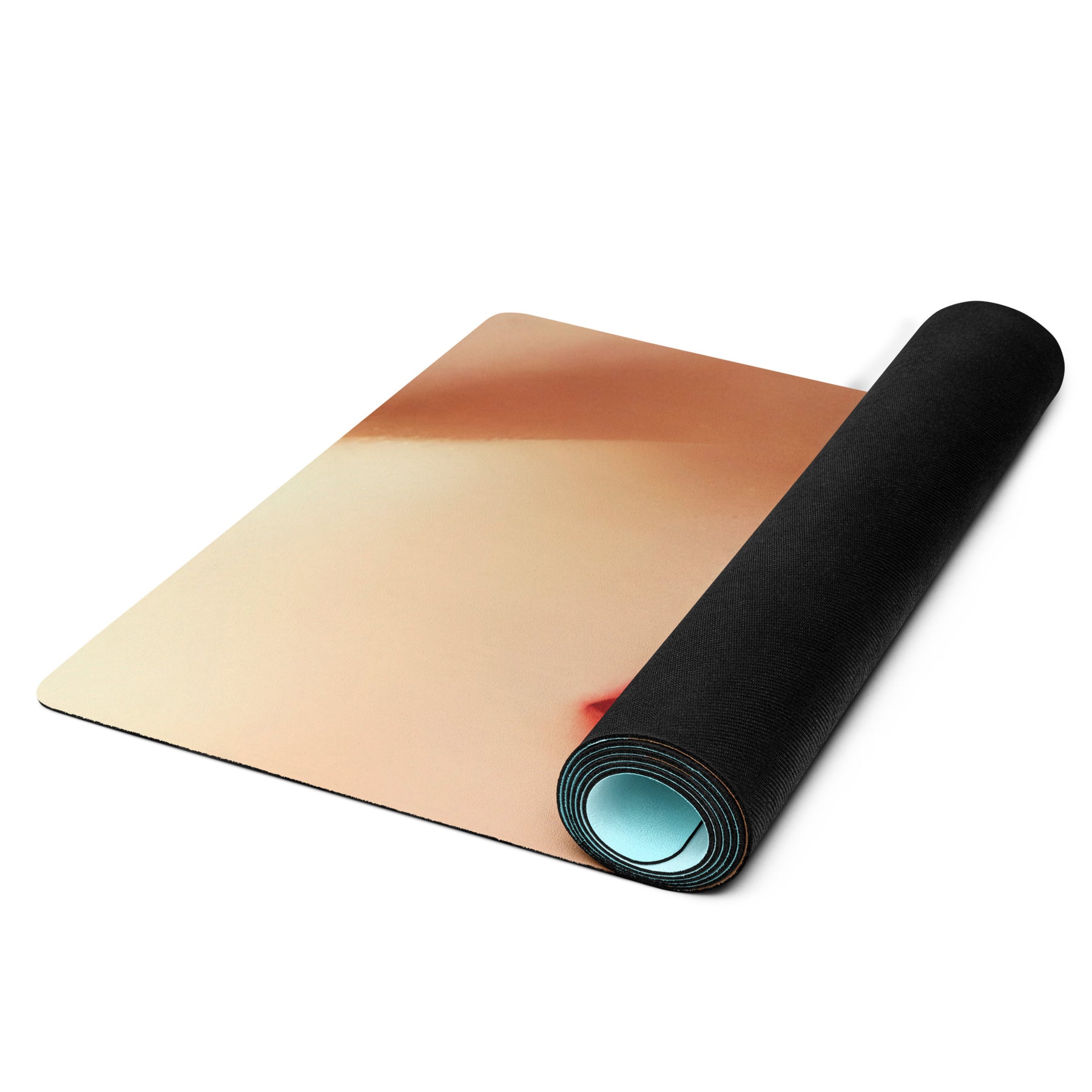 a rolled up yoga mat starting to unfold showing a partial hand