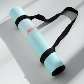 a rolled up yoga mat with black straps