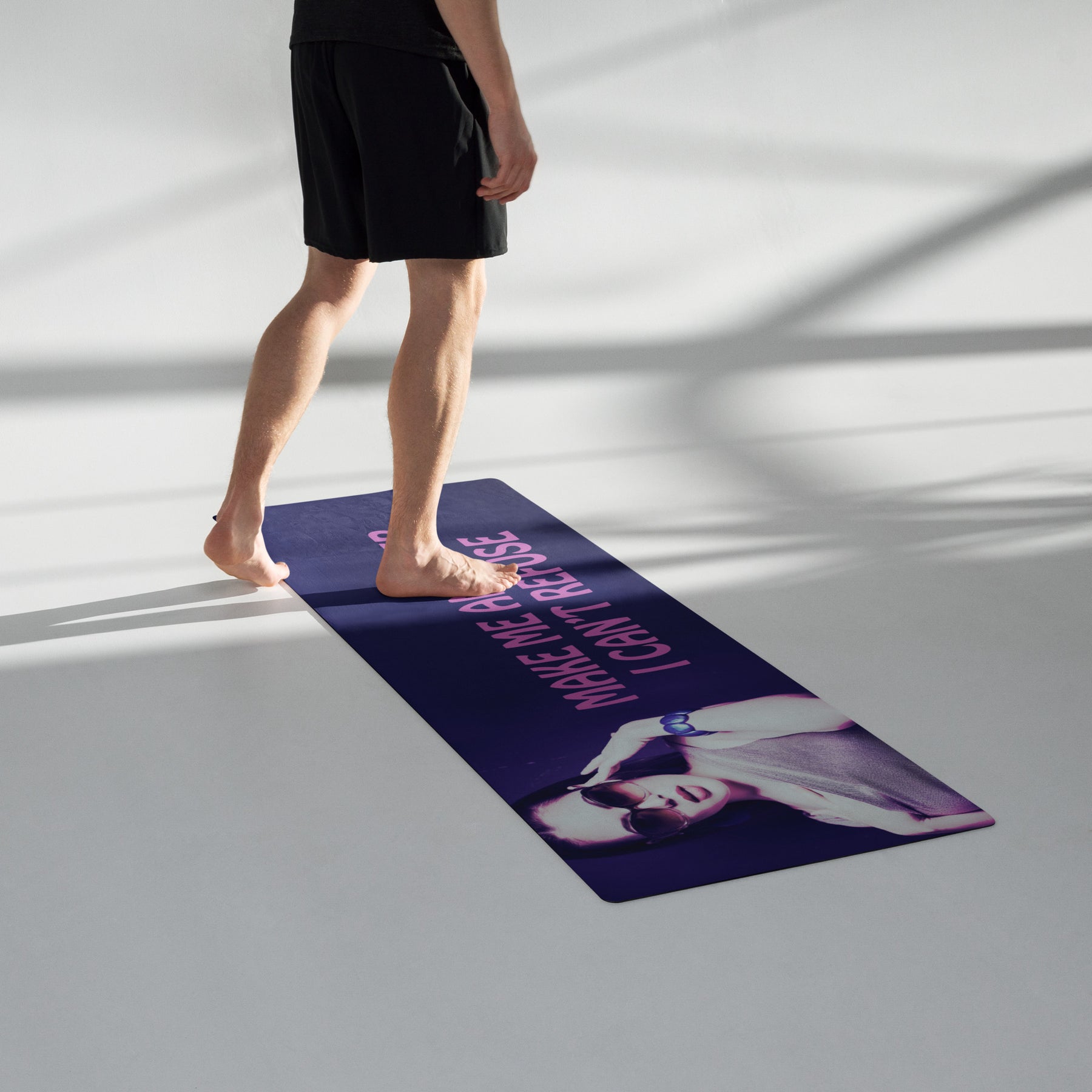 man in a room standing on a Yoga mat with a purple wrap and an image of a young woman in sunglasses. There is pink text that reads Make Me An Offer I Can't Refuse