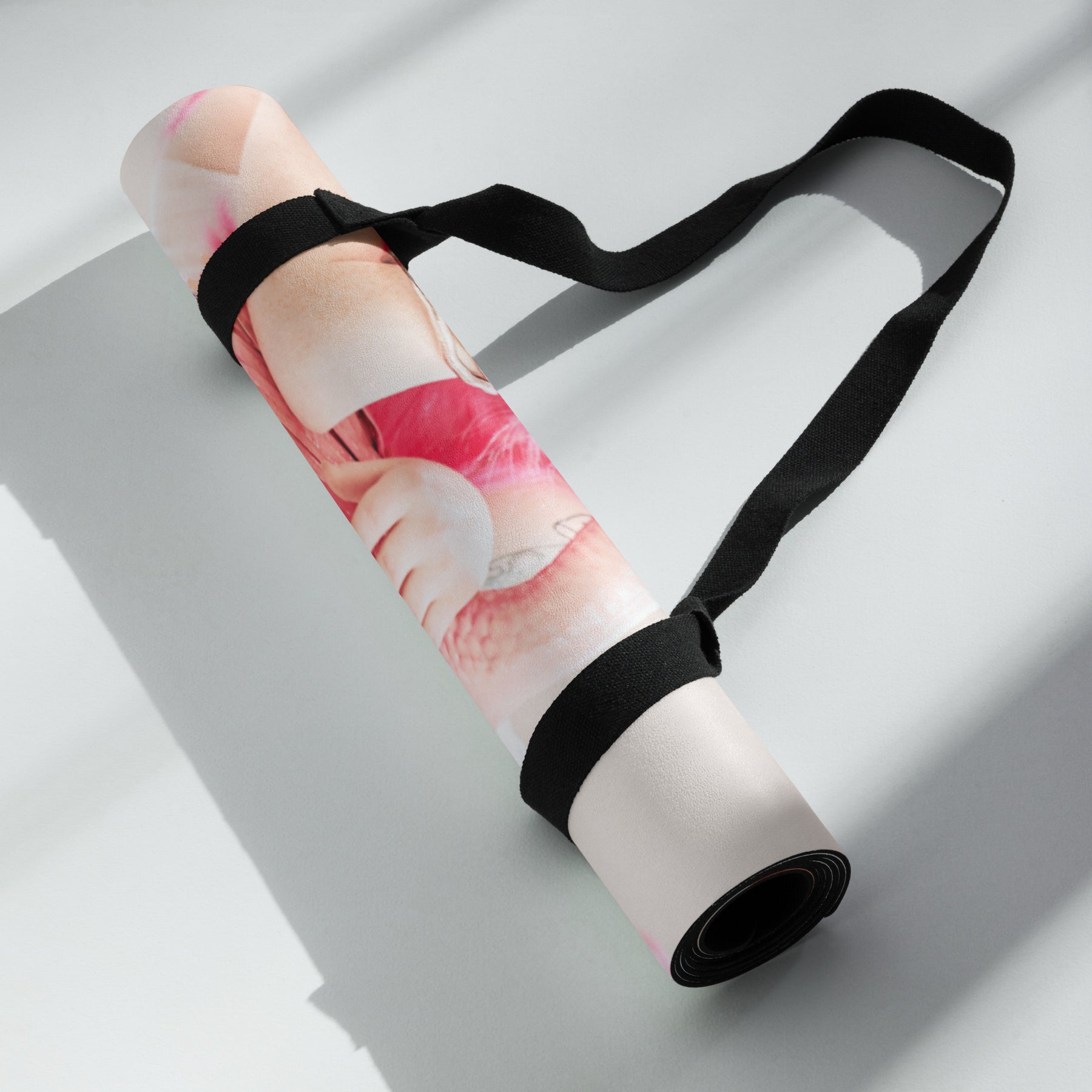 a rolled up yoga mat of a girl in a pink wig with pink flamingos